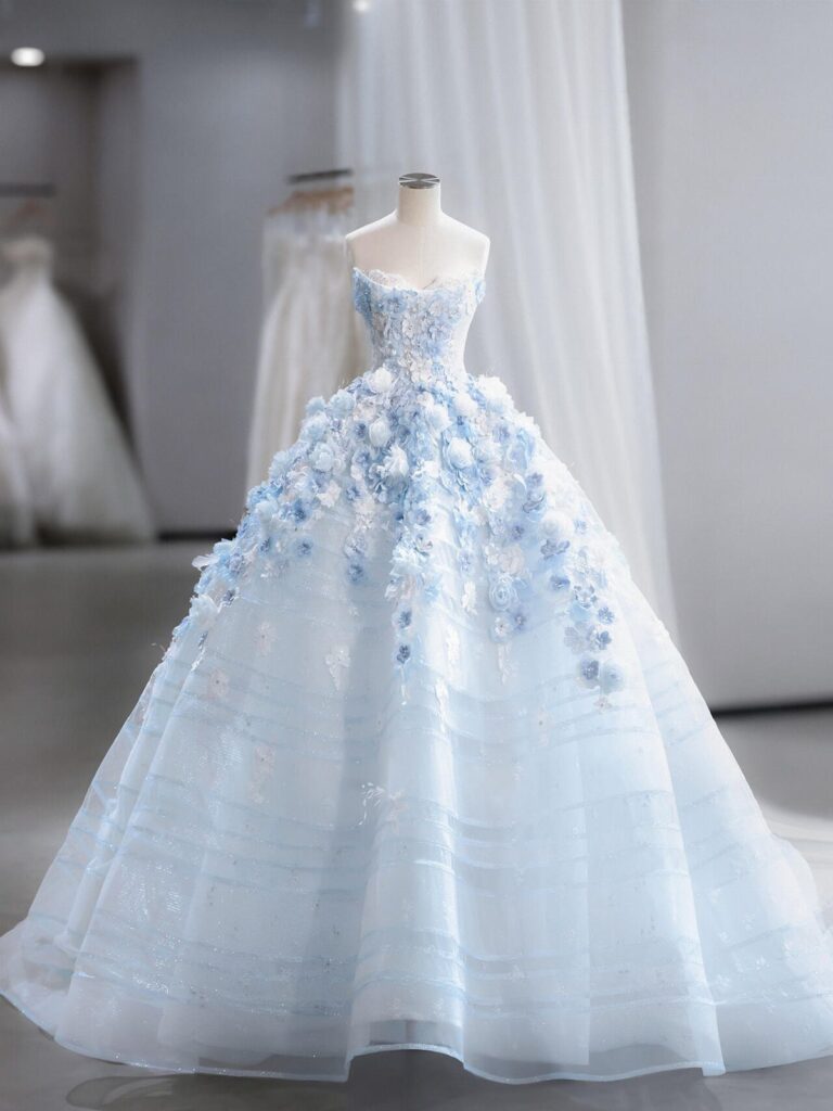 Light blue strapless wedding dress with floral details on a white mannequin.