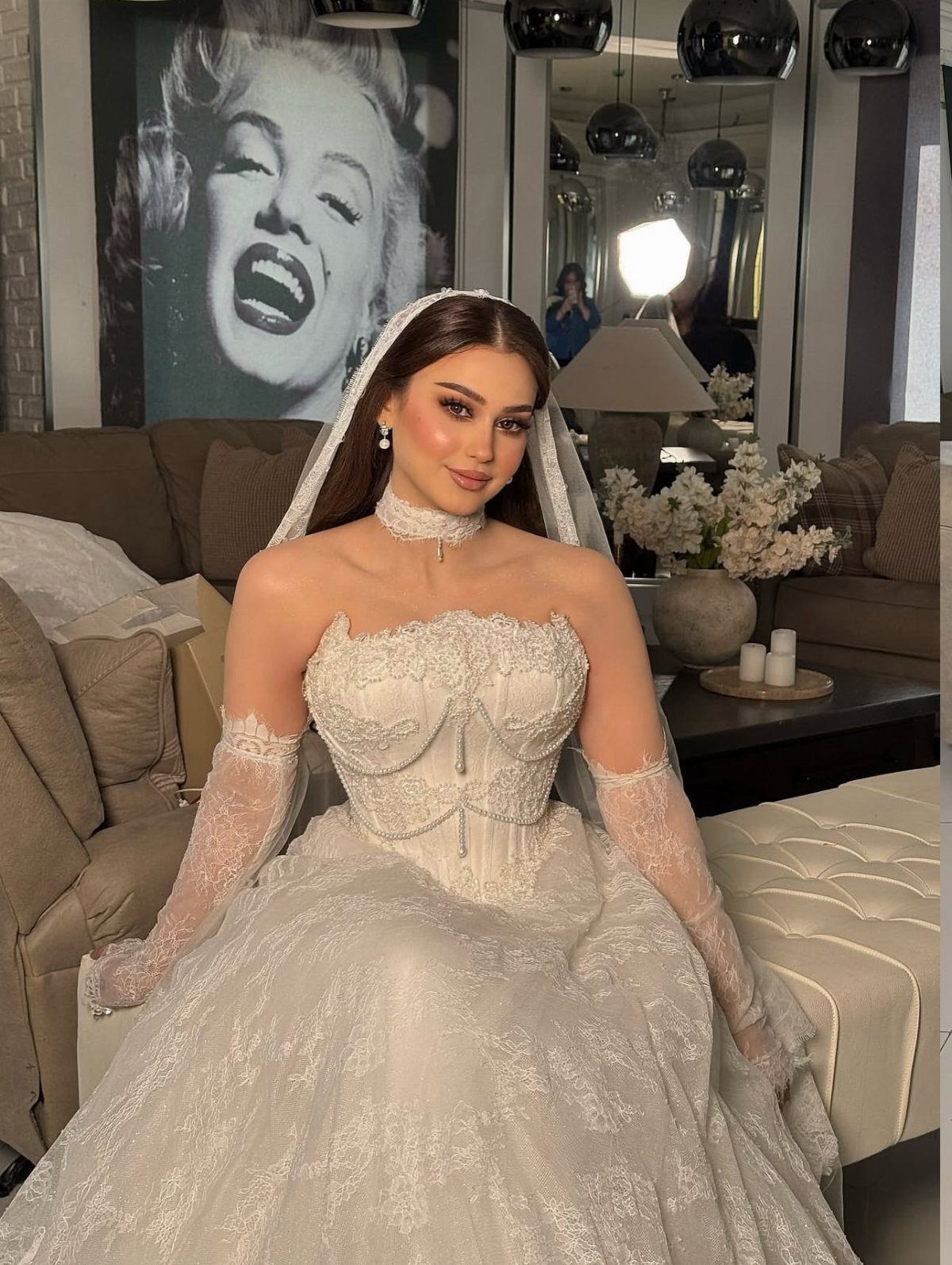 Woman in a white lace wedding dress with a corset bodice and bridal veil.